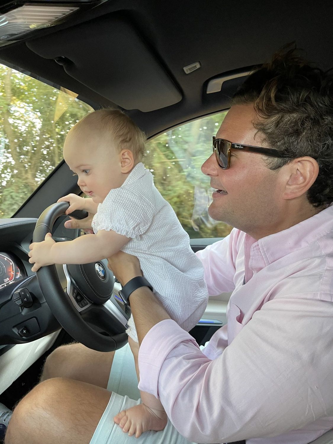 Alex Davey with a young daughter at the steering wheel of a car