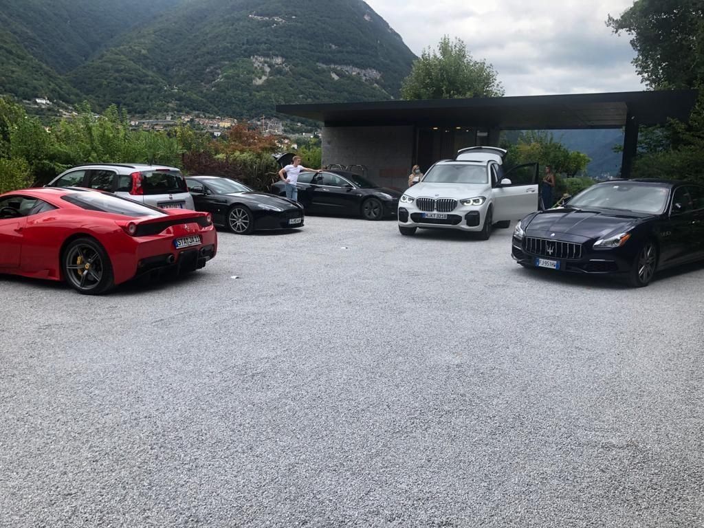 Several cars parked at a hillside villa